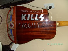 back of the Fender Kingman, with some more Egyptian motif paint and Woody Guthrie&#39;s favorite saying, that was written on all of this guitars.