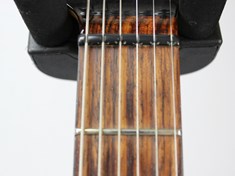 In this photo you can get a good view of the Music Man compensated nut. The staggered cut allows for more accurate temperament over the fretboard. The result is chords that sound more sonorous and vibrant, with intonation dissonance minimized.