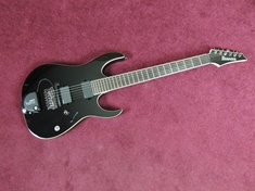 As radical as the RG body style may be in contrast to a Strat or LP, I think the gloss black, white binding, no fret inlays and simple appointments make this guitar as understated as possible for a pointy shred machine.