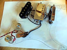 This was the first iteration of the pickguard. Telecaster pickups from a &#39;52 AVRI Tele, and a PAF-copy between them. It ended up sounding great.