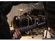 While on a break during practice, I sat down with my camera and this is what I saw. My drums focused in the background, while Derek plays guitar as Brad leans over to control Pro Tools in the foreground.